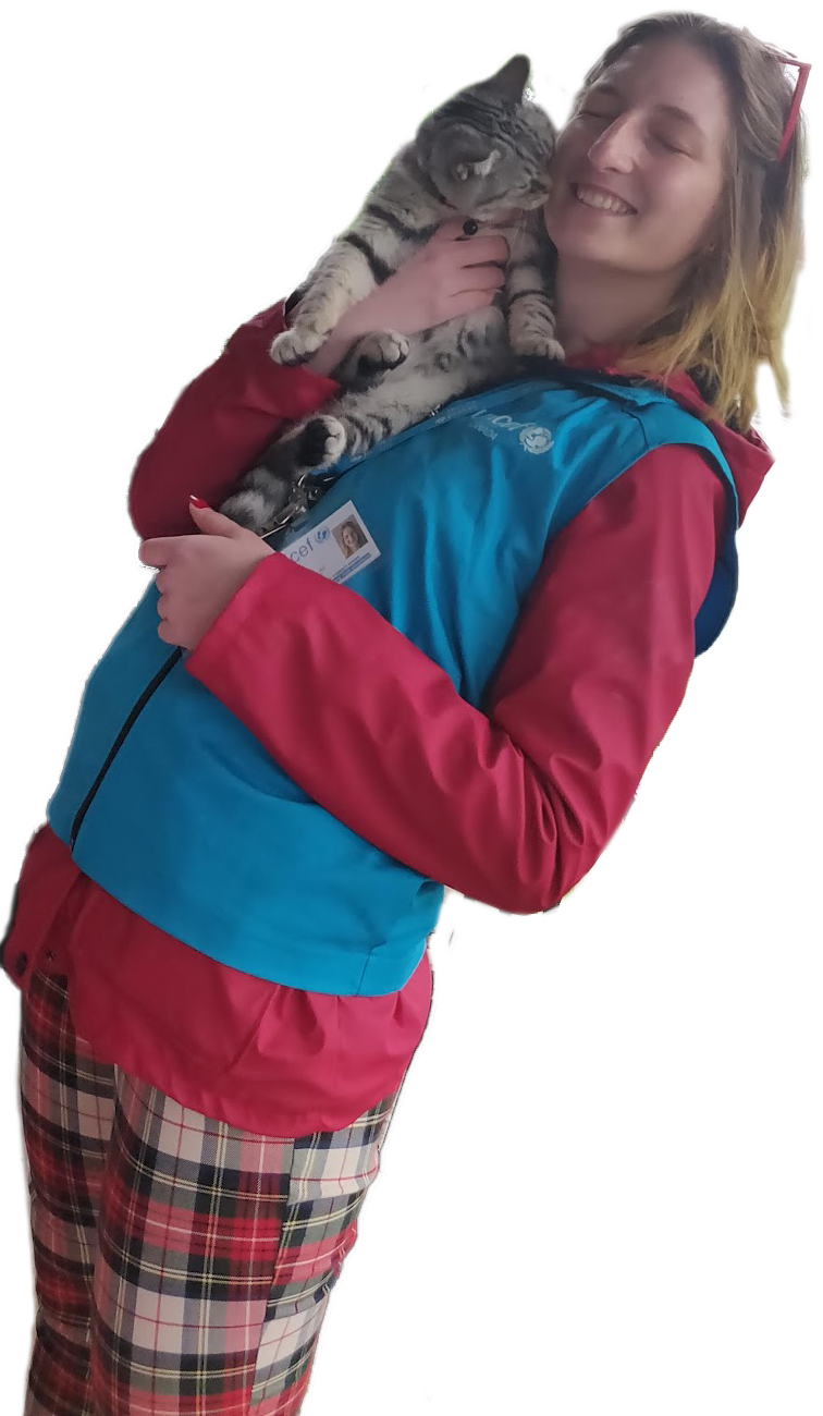 Me in a UNICEF vest holding a street cat while fundraising